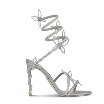 Роскошные дизайнерские женские сандалии Змея Высокие каблуки Серебряные туфли с круглым носком Летние элегантные туфли-лодочки Узел-бабочка Украшение шпильками